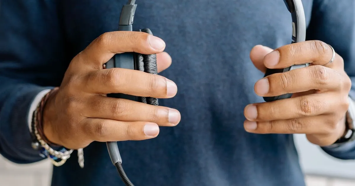 A person holding a customer-service headset
