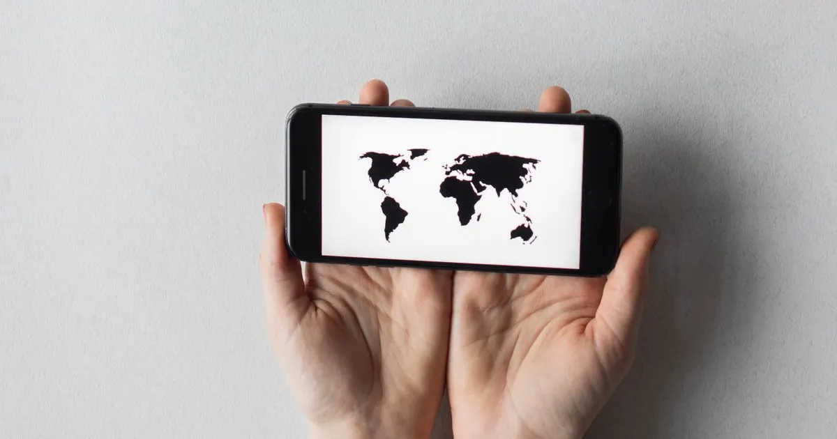 A world map shown on a smartphone screen